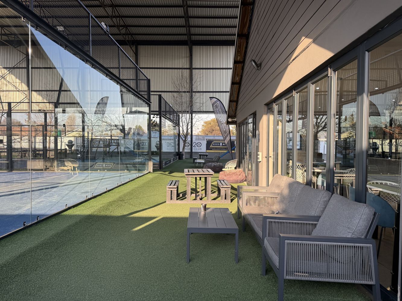 Outdoor social terrace next to the covered courts at Three Rivers